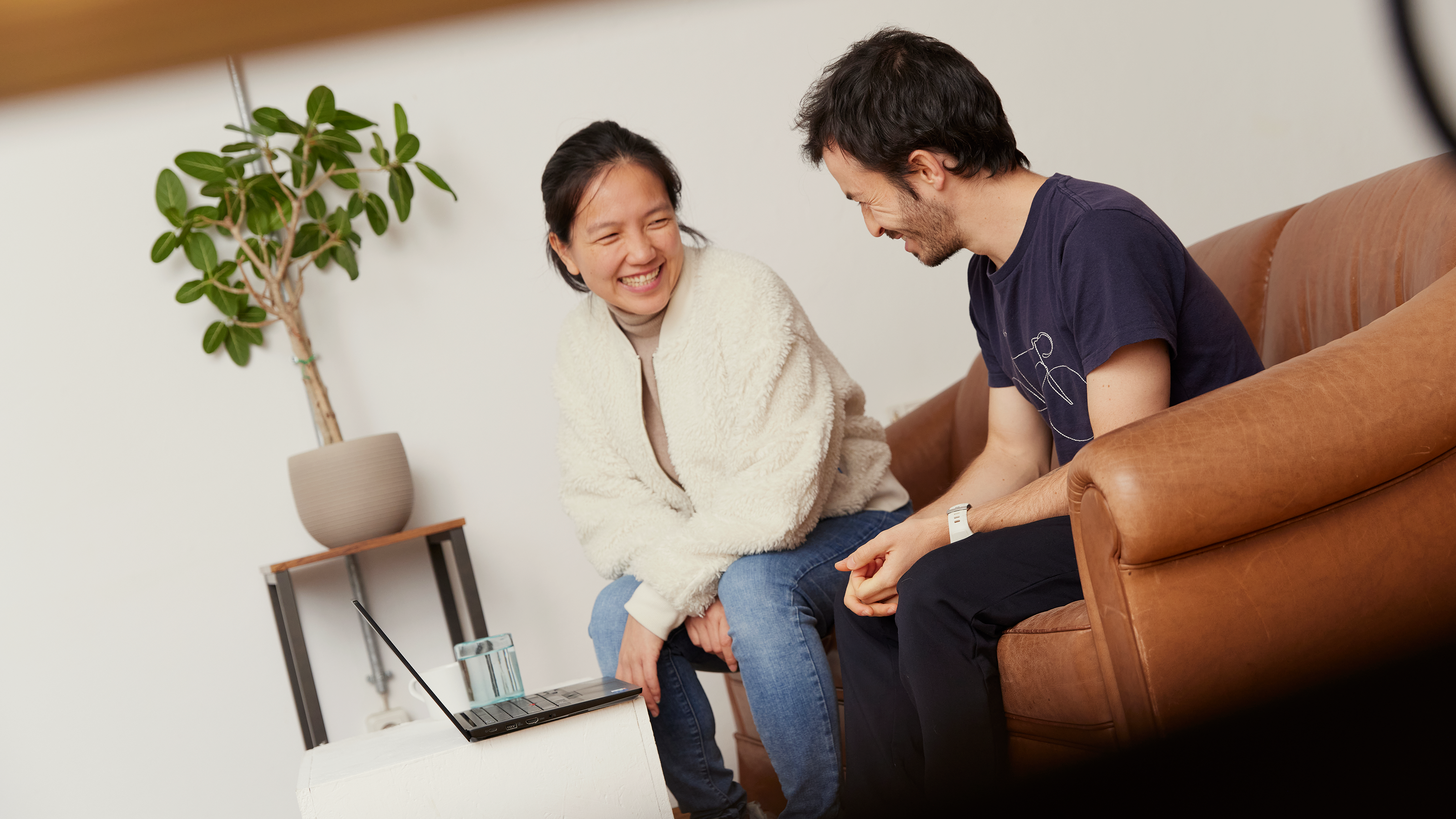 two people laughing while talking
