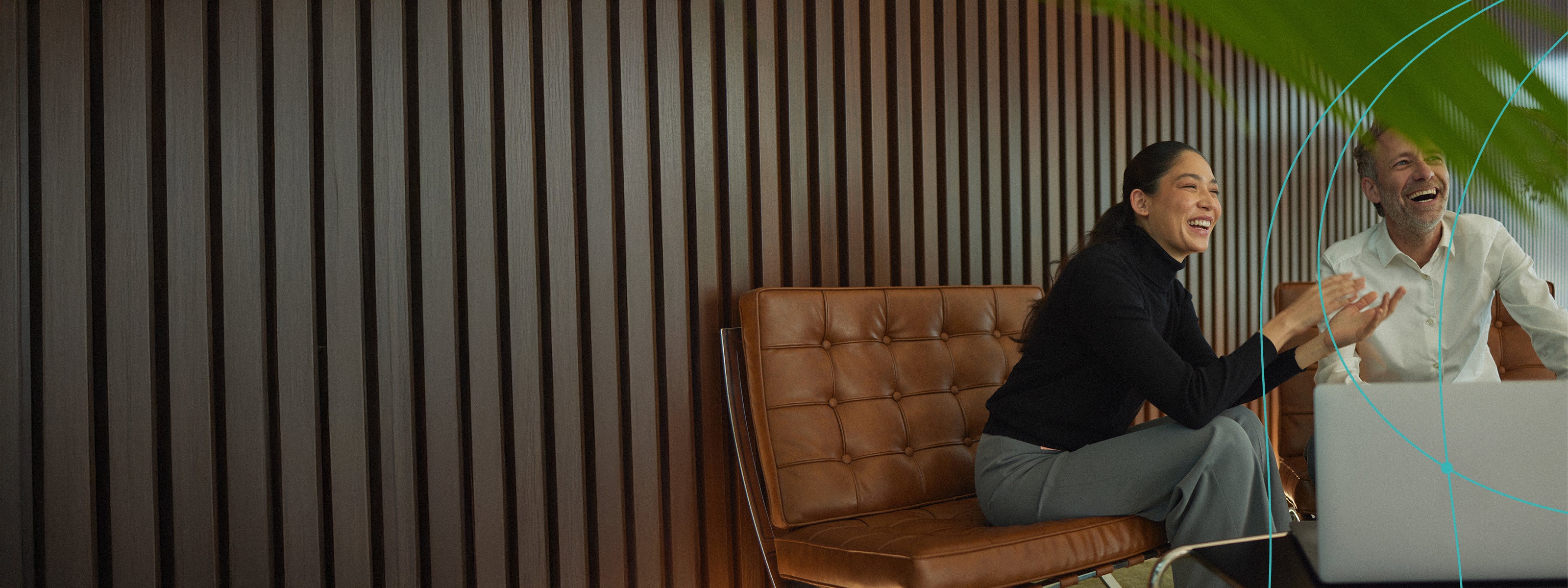 Man and woman sitting and laughing together in a relaxed setting - Retraced's partners