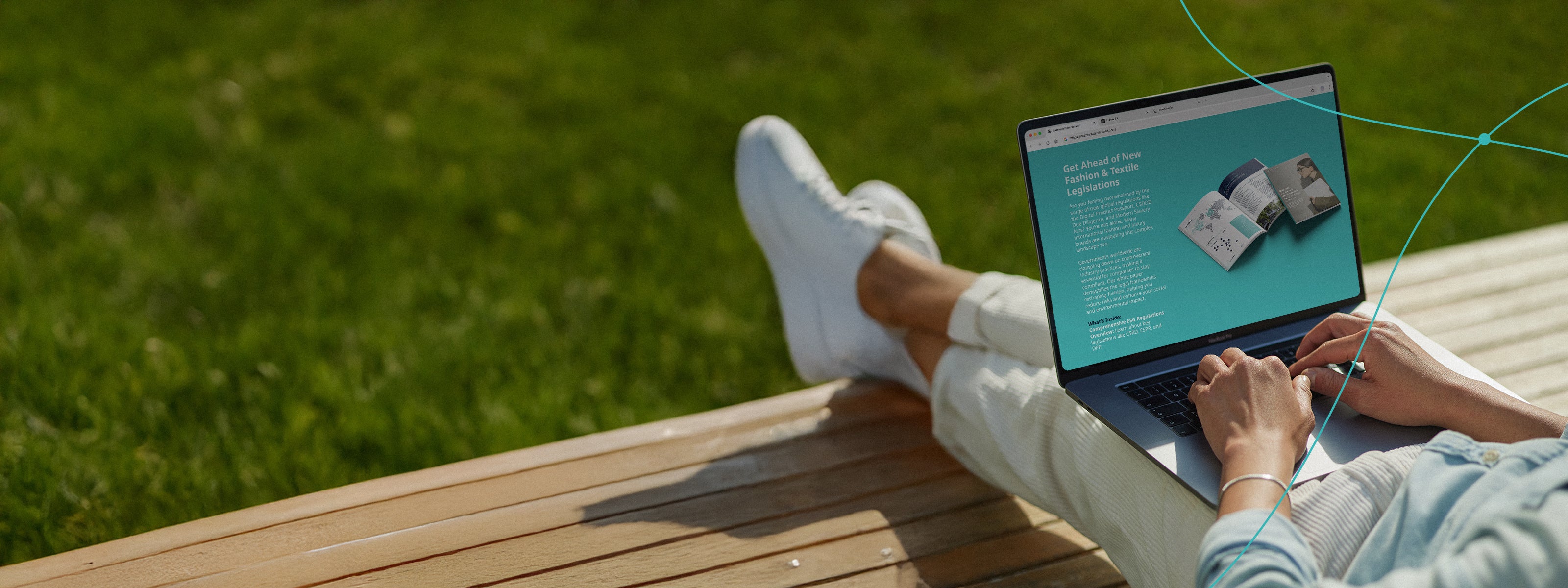 Person sitting outdoors with a laptop displaying Retraced’s eBook Get Ahead of New Fashion and Textile Legislation