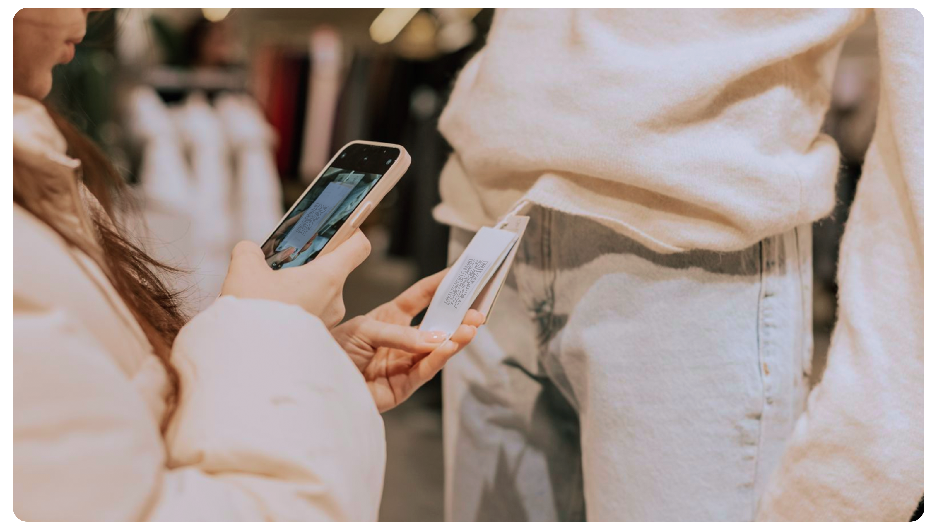 Woman scanning a garment label with her phone to access product data via the Digital Product Passport (DPP)