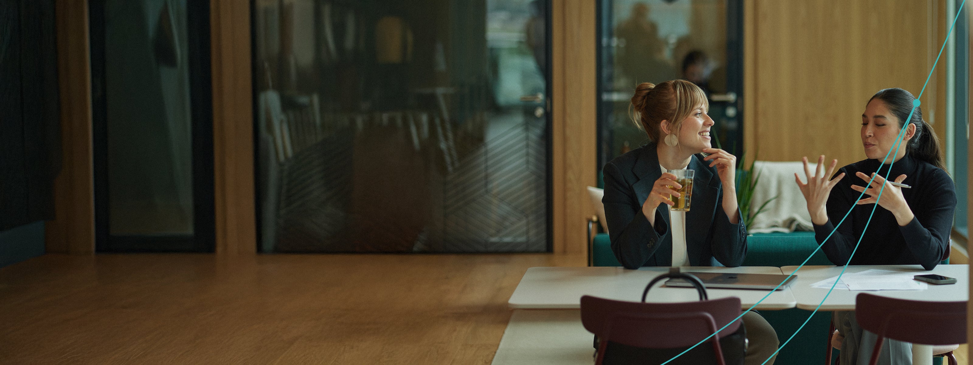 Two women talking and working 